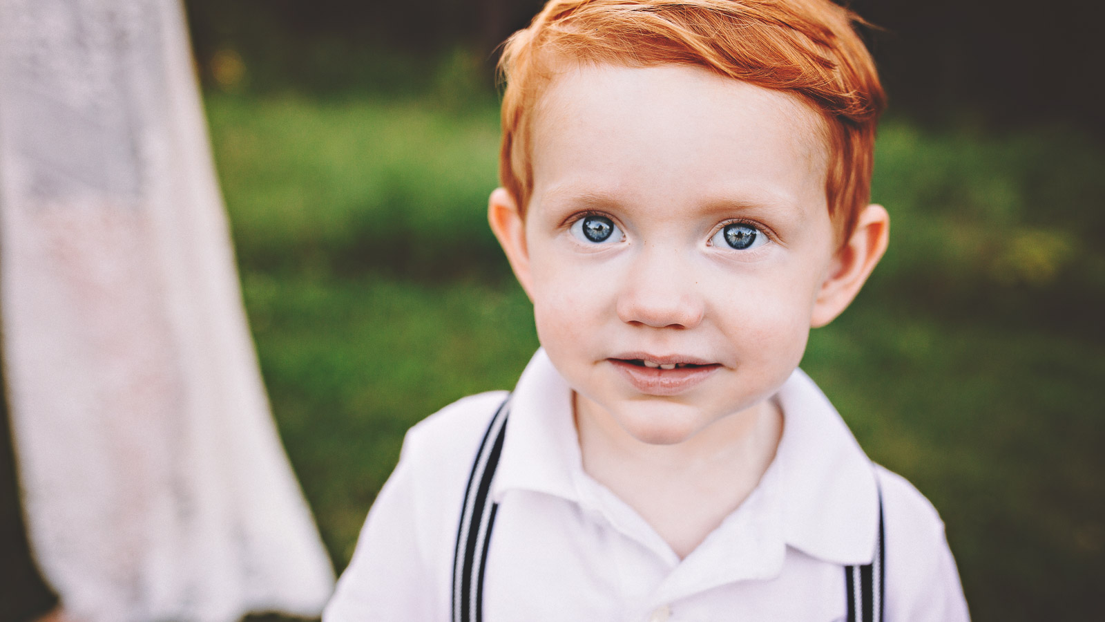 photograph of an adorable red headed little boy smiling at jester park in iowa